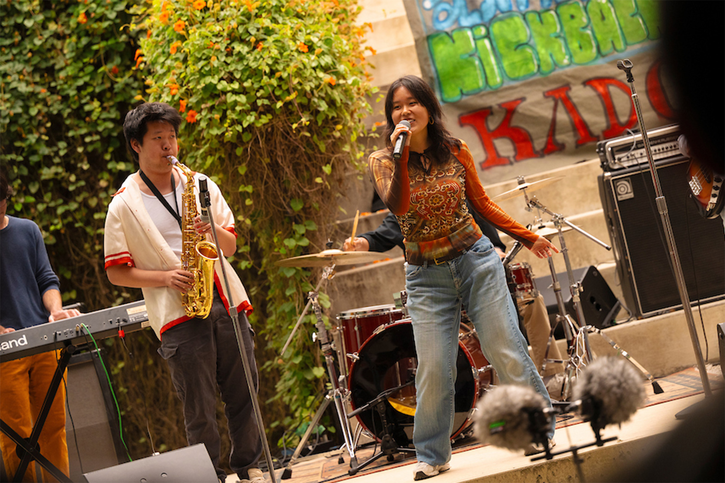 Two people play instruments on stage