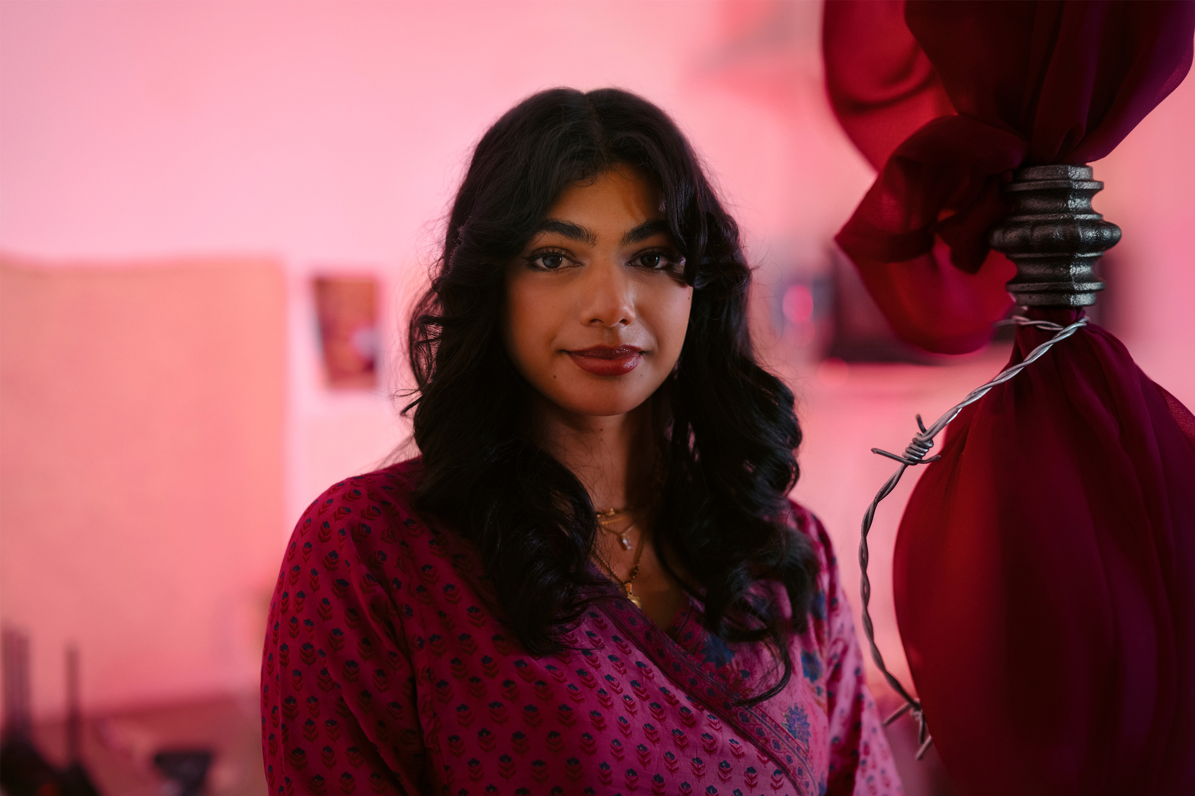 Student portrait with pink hued background